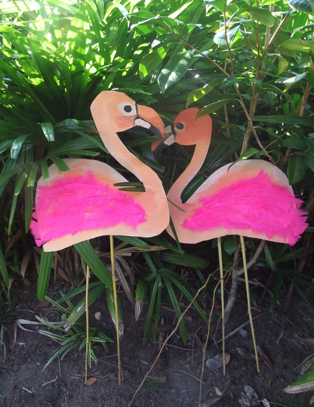 a two pink flamingos